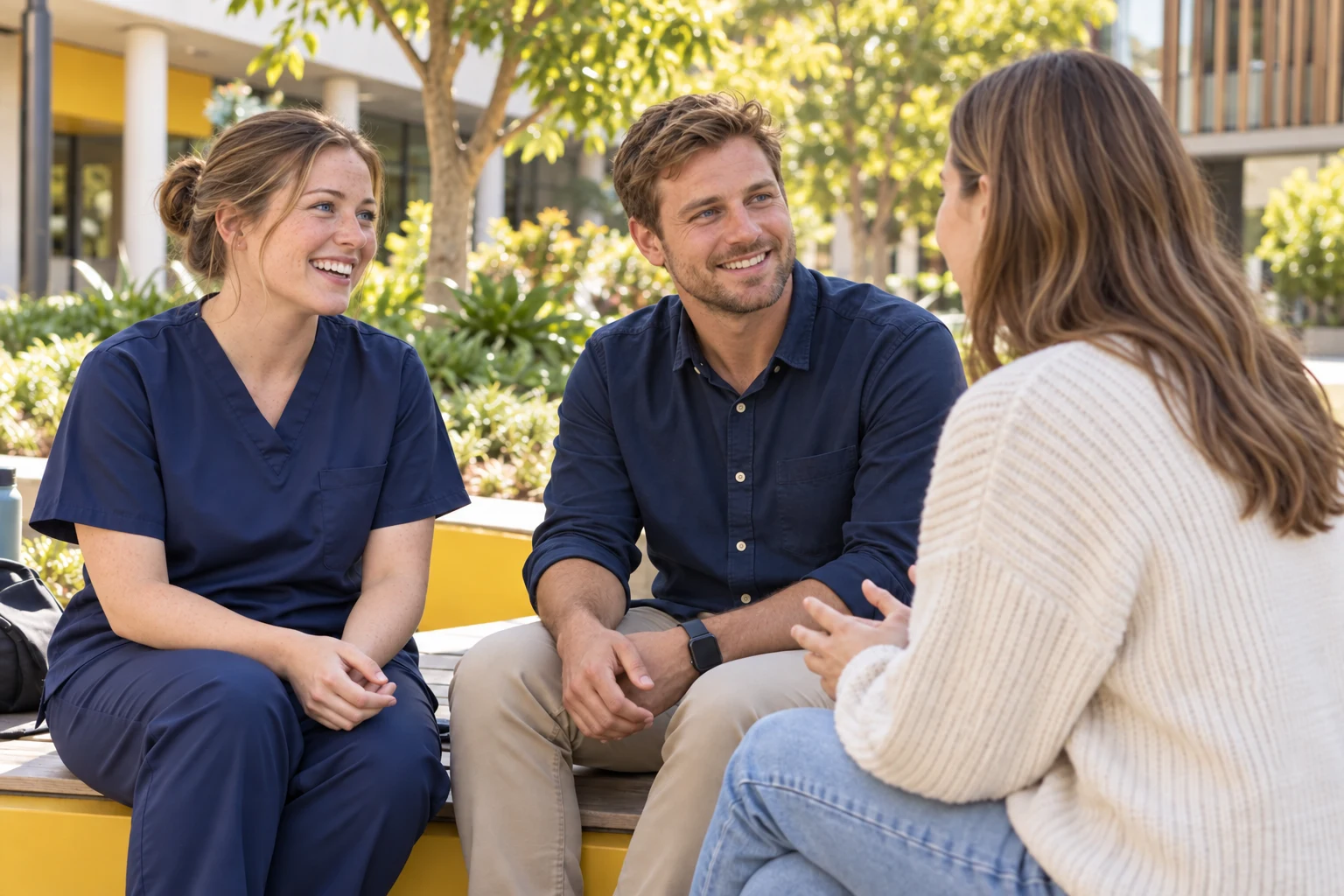 Students sharing a relaxed conversation on campus